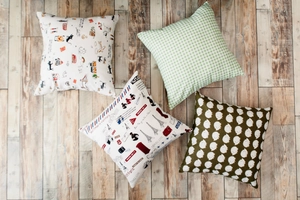 Flat lay of Nordic cotton-linen cushion covers with cat, grid, Paris, and hedgehog patterns
