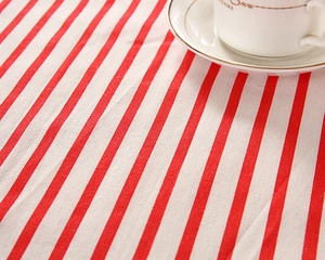 Detail of red and white striped cotton fabric with natural linen texture for table decor