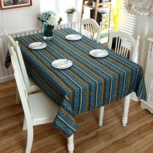 Detail of bohemian striped linen tablecloth with lace trim and vibrant geometric patterns