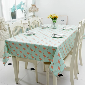 Detail showing pink flamingo patterns on mint green tablecloth on a white table