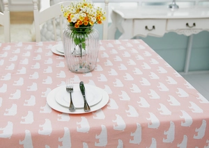 Macro view of the pink linen-blend tablecloth with white polar bear pattern prints