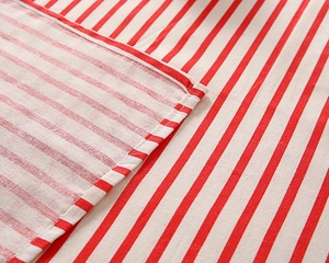 Close-up of red and white striped cotton-linen fabric with detailed flat weave texture
