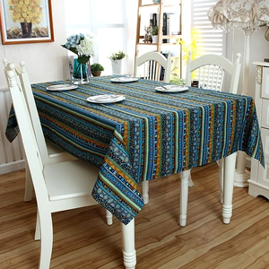 Detail of bohemian colorful striped tablecloth with rustic cotton linen texture on wood table