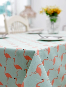 Detail of mint green flamingo print tablecloth showing fabric texture and drape quality