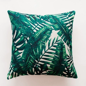 Macro shot showing cotton linen texture and hidden zipper on tropical leaf pillow cover