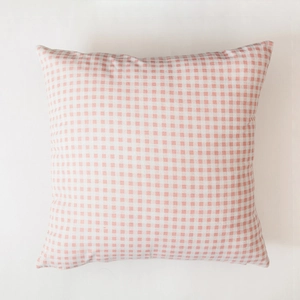 Close-up of pink and white gingham pattern fabric texture on a square cushion cover