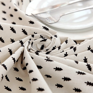 Modern minimalist beige table cloth with black pine tree print and linen texture