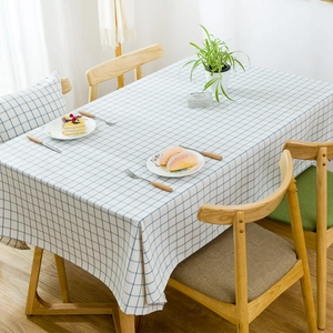 Close-up of blue and white checkered waterproof tablecloth on a wooden table