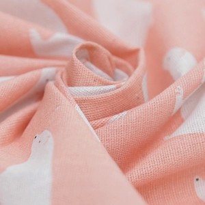 Macro shot of soft pink polar bear print fabric with visible woven linen texture