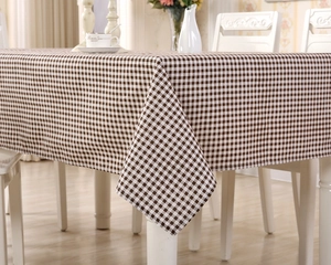 Close-up of deep coffee and white gingham cotton tablecloth in a cozy dining setting