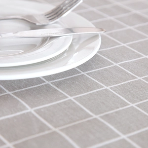 Detail of grey plaid tablecloth with white grid pattern showing fabric texture and weave