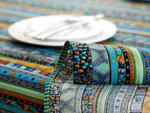 Detail of bohemian striped linen tablecloth showing fine stitching and woven texture