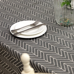 Close-up of modern grey chevron pattern tablecloth with linen texture and geometric lines