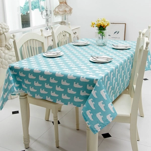 Close-up of polar bear print on teal linen tablecloth with elegant home decor setting