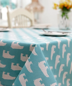 Detail of light blue tablecloth featuring polar bear print with premium fabric drape