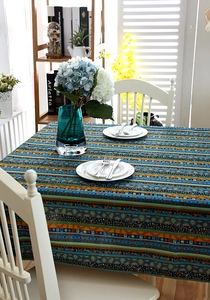 Detailed top view of geometric ethnic pattern tablecloth with lace trim on a dining table