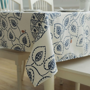 Detail of leaf pattern and red ladybug print on thick cotton canvas tablecloth