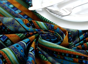 Detail of ethnic geometric stripe pattern on thick linen tablecloth with lace edges