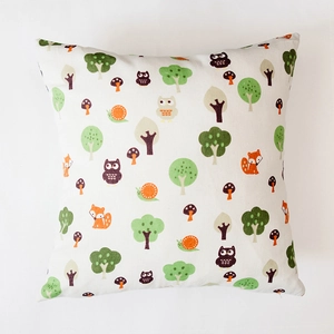 Close-up of cotton linen pillow cover with cartoon forest animals and tree patterns