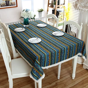Close-up of bohemian striped linen tablecloth with decorative white lace border trim