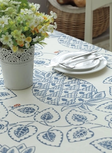 Detail of leaf and blue pineapple print on cotton canvas tablecloth with ladybug motifs
