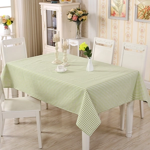 Detail shot of green and white plaid rectangular fabric tablecloth with a soft drape