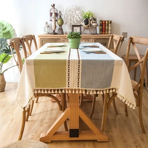 Detail of jacquard tablecloth showing woven texture with tassels and geometric embroidery
