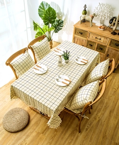 Close-up of geometric plaid tablecloth with white fringe tassels and matching chair pads