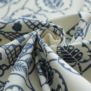 Macro shot of thick cotton canvas fabric with vintage blue leaf pattern and woven texture
