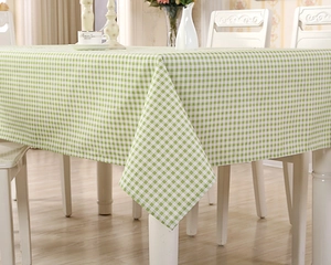 Detail showing high-density green and white checkered tablecloth texture and drape effect