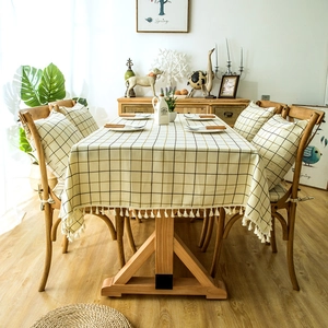Close-up of geometric plaid tablecloth with tassel trim and matching chair cushion set