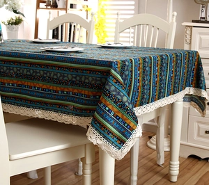 Detail of bohemian stripe tablecloth featuring elegant cream lace edges on a white table