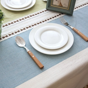 Detail of blue and beige jacquard tablecloth with hollowed-out wavy lace edge