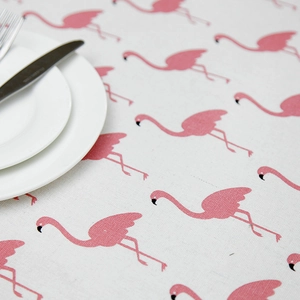Macro detail of cartoon flamingo print on fresh linen-cotton blend tablecloth fabric