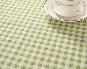 Close-up of green and white checkered tablecloth fabric with detailed woven texture