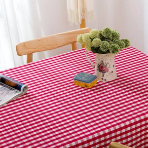 Modern red and white checkered waterproof tablecloth on a rustic wooden dining table