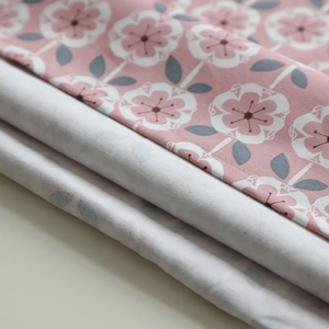 Detailed macro view of the thick cotton canvas fabric with pink leaf and floral patterns