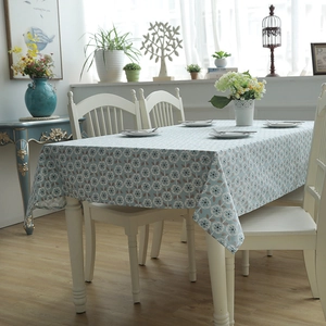 Detail of blue floral cotton canvas tablecloth with white circular flower patterns