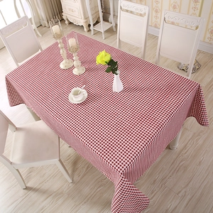Detail shot of a red and white checkered tablecloth with a cozy home dining aesthetic