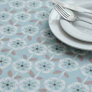 Detail of blue floral cotton canvas tablecloth with thick texture and Nordic leaf print
