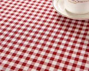 Close-up detail of red and white checkered tablecloth texture with cotton linen weaving