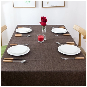 Waterproof dark brown linen textured tablecloth on a modern dining table with plates