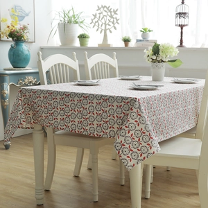 Detailed view of thick cotton canvas tablecloth featuring grey floral and red leaf patterns
