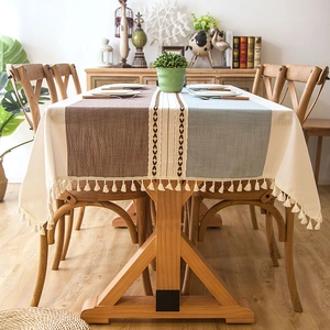 Detail of bohemian jacquard tablecloth featuring fringe edges and tricolor patchwork