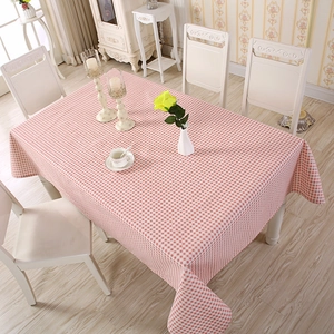 Close-up of pink and white checkered tablecloth with a cozy home dining decoration