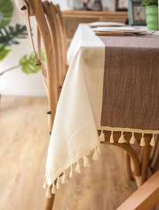 Detail of waterproof jacquard tablecloth with fringe and beige coffee color stitching