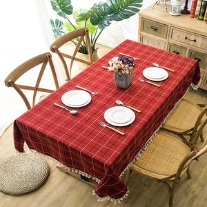 Macro shot of red plaid tablecloth texture with white tassel edge and linen finish