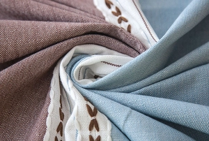 Detail of waterproof jacquard tablecloth with Nordic embroidery and fringe textures
