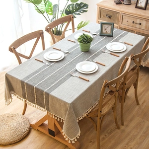 Minimalist jacquard linen tablecloth with neutral stripes and elegant tassel fringe detail