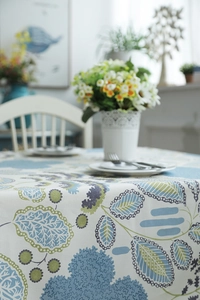 Detailed fabric texture of a modern minimalist floral cotton tablecloth with leaf pattern